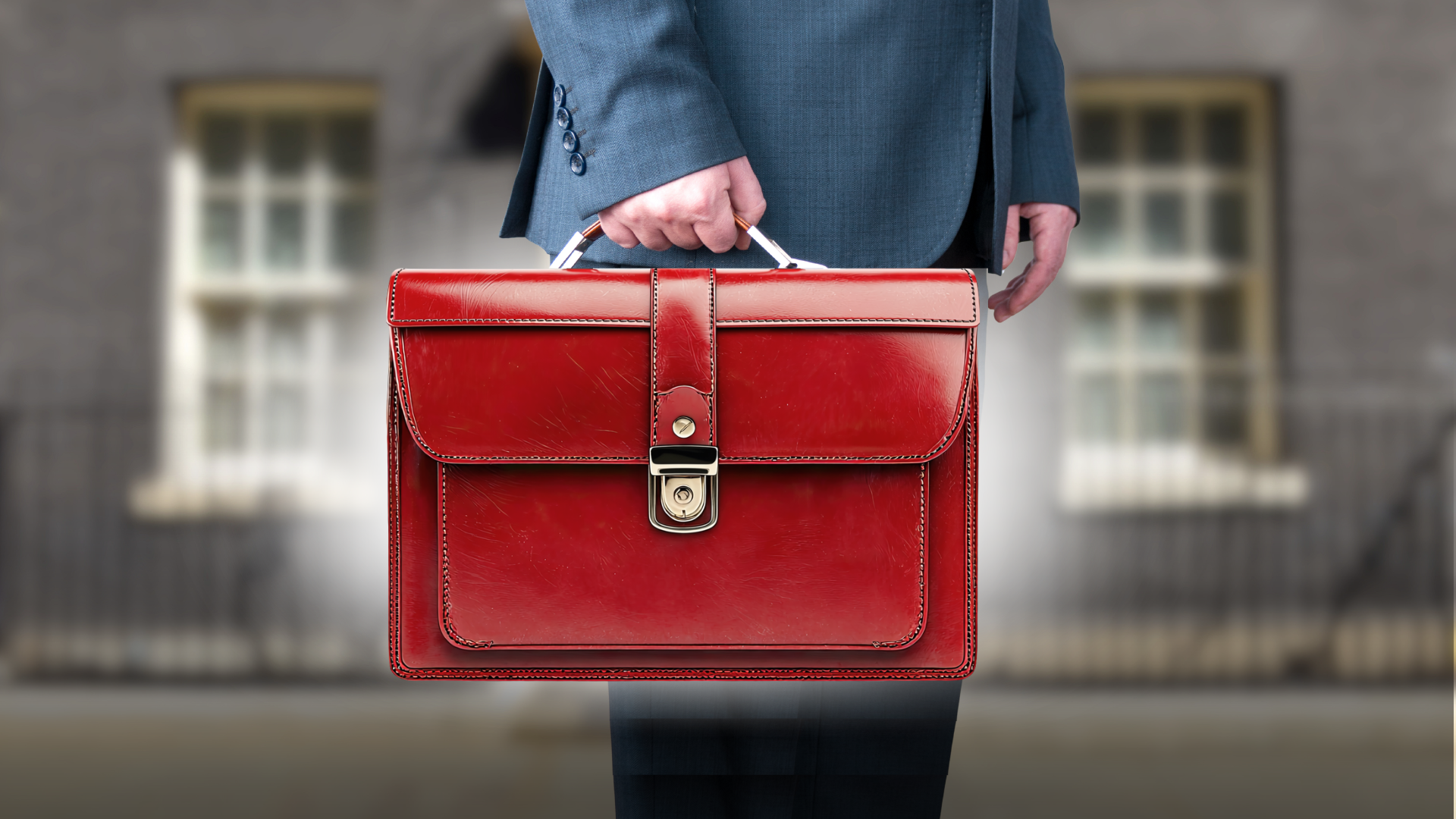 A man holding a red briefcase.